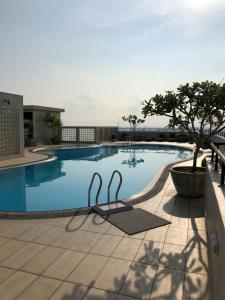 a swimming pool with two metal chairs on a patio at Hedges Court Residencies -Town Hall- 2 Room 3 Bed Apartment in Colombo