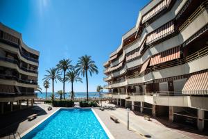 a view of the beach from the balcony of a building at Apartamentos Marina sol de España in Cambrils