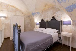 a bedroom with a bed in a room withpainted ceilings at Dimore Briganti Gallipoli Centro in Gallipoli +88 photos