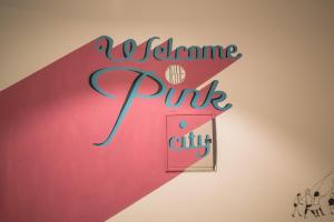 a sign for a wine pink entity on a wall at Zostel Jaipur in Jaipur