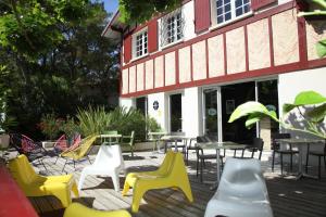 a group of chairs and tables on a patio at Hôtel La Paloma in Hossegor