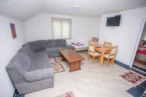 a living room with a couch and a table at Apartments River 1 in Bihać