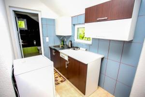 a small kitchen with a sink and a refrigerator at Apartments River 1 in Bihać