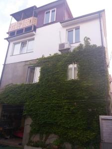 a building with ivy growing on the side of it at Дом у моря Одесса in Odesa