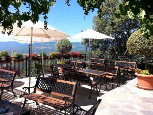 a group of tables and chairs with an umbrella at Cal Serni in Calbinyà