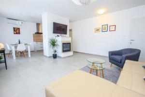 a living room with a couch and a table at Family Beach Apartments in Peroj