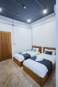 מיטה או מיטות בחדר ב-Hug Inn Phrae
