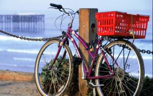 a bike chained to a post with a red basket at Pacific Terrace Hotel in San Diego