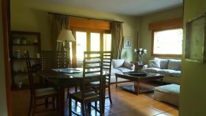 salon ze stołem, krzesłami i kanapą w obiekcie Casa Bonita Navacerrada w mieście Navacerrada