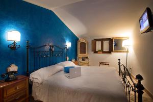 a bedroom with a bed with a laptop on it at Agriturismo Il Sapore Della Luna in Monteprandone +73 photos