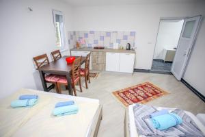 a kitchen and dining room with a table and chairs at Apartments River Una 3 in Bihać