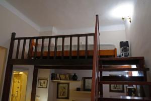 a wooden staircase in a room with a bunk bed at Oaza centar in Novi Sad