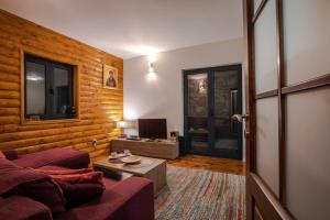 a living room with a couch and a tv at Guest house Heaven in Žabljak