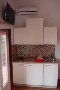 a kitchen with white cabinets and a sink at Villa Lina in Ičići