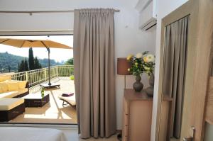 
a room with a window with a view of a balcony at ARILLAS HILLSIDE VILLA 3 - Provence in Arillas
