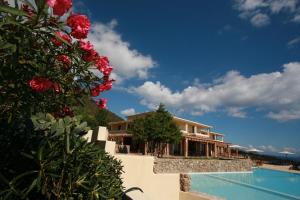 a house with a swimming pool next to a house at Hotel Villa Gustui Maris in Cala Gonone