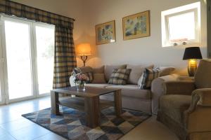 
a living room filled with furniture and a window at ARILLAS HILLSIDE VILLA 3 - Provence in Arillas
