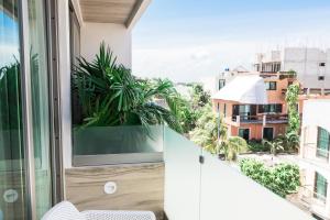 a balcony with a view of a city at Newport House Playa Boutique Hotel in Playa del Carmen