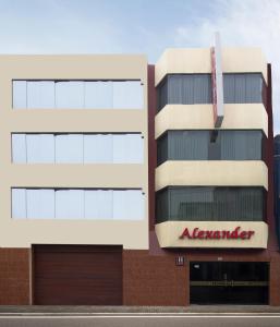 a building with a sign on the side of it at Hotel Alexander in Trujillo