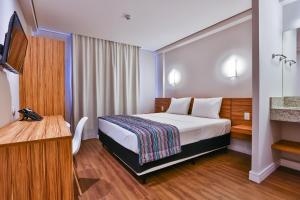 Postelja oz. postelje v sobi nastanitve Maringá Airport Hotel