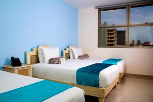 Ліжко або ліжка в номері Hotel Med Centro - Marcari