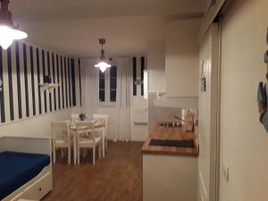 a living room with a kitchen and a dining room at 3 Gracije in Koper