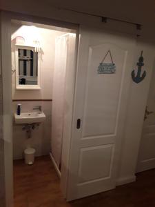 a bathroom with a white door and a sink at Tri Gracije in Koper +18 photos