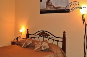a bedroom with a bed with two lamps and a picture at Salute Hotel in Belgorod