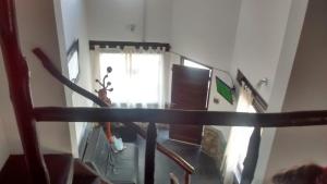 a person walking down a staircase in a living room at Casa El Mortero in Cafayate