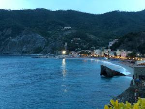 a view of a beach at night with a town at Albamare in Monterosso al Mare