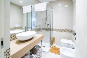 a bathroom with two sinks and a glass shower at Sanremo Home Loft in Sanremo +19 photos