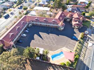 an overhead view of a house with a swimming pool at Abel Tasman Motor Inn in Dubbo