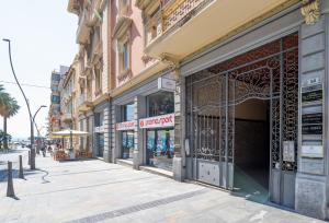 a building with a gate on a city street at Sanremo Home Loft in Sanremo