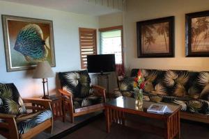 a living room with couches and a coffee table at Kailani Suite at hana Kai Resort in Hana