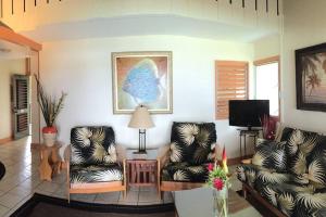 a living room with two chairs and a table at Kailani Suite at hana Kai Resort in Hana