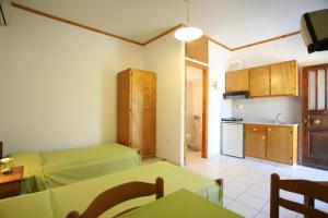 a living room with two beds and a kitchen at Caviri in Galissas