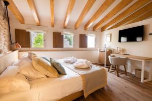 a bedroom with a bed and a desk in a room at Forum Boutique Hotel & Spa - Adults Only in Alcudia