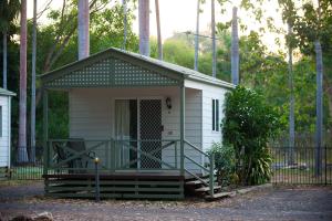 a small white house with a porch and a gate at BIG4 Howard Springs Holiday Park in Darwin