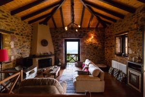 a living room with couches and a fireplace at Luxury House In The Hills in Sparti