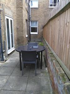 a table and chairs sitting on a patio at 64 Wardo Avenue in London +3 photos