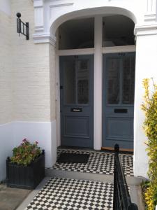 a front door of a house with a blue door at 64 Wardo Avenue in London