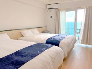 Postel nebo postele na pokoji v ubytování Hotel Sakurano Familia Nago