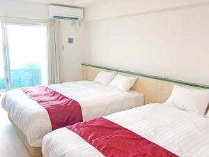 Postel nebo postele na pokoji v ubytování Hotel Sakurano Familia Nago