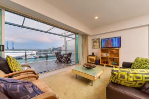 a living room with a large window with a view at QV Private Absolute Waterfront Auckland - 263 in Auckland