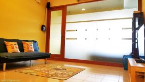 een woonkamer met een glazen schuifdeur bij Cempaka Service Suite Unit - PRIVATELY OWNED in Kuala Lumpur