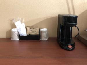 a coffeemaker sitting on a table with a coffee maker at Knights Inn Motel in Grants Pass