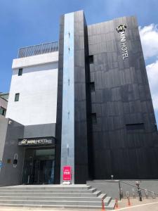 a large building with stairs in front of it at Mini Hotel 141 in Gyeongju