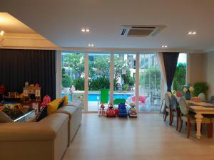 a living room with a couch and a table at 3 bedrooms My resort huahin with free waterpark in Hua Hin