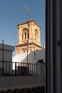 a clock tower on top of a building at Casa Palacio López Daza in Granada