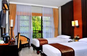Una cama o camas en una habitación de Sari Ater Hotel & Resort